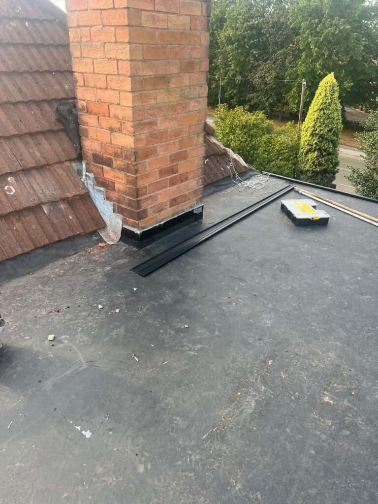 This is a photo of a flat roof which has just been repaired, there is also a chimney stack and some leadwork has also been dressed. Works carried out by Wednesbury Roofing Repairs